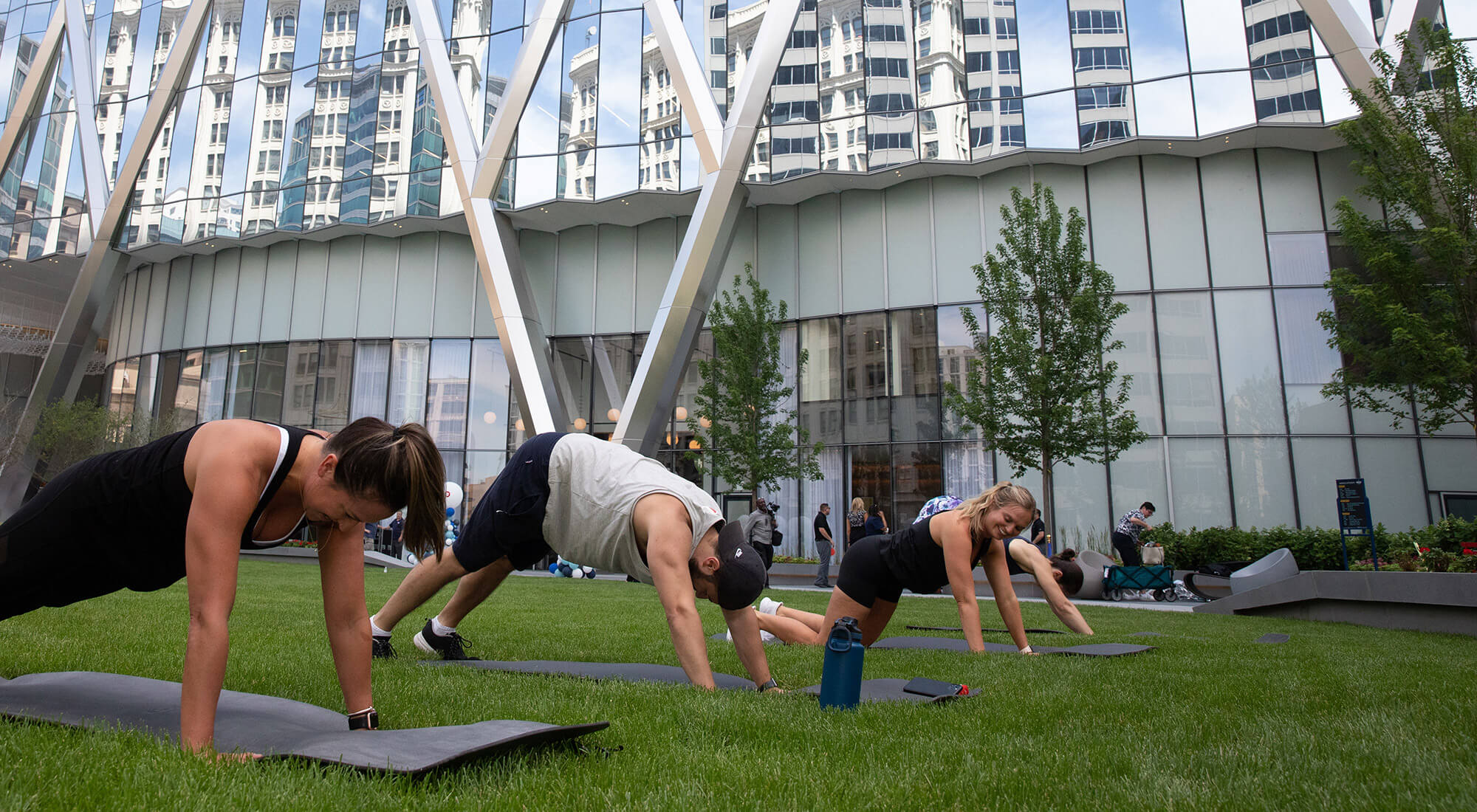 4 people doing yoga on grass