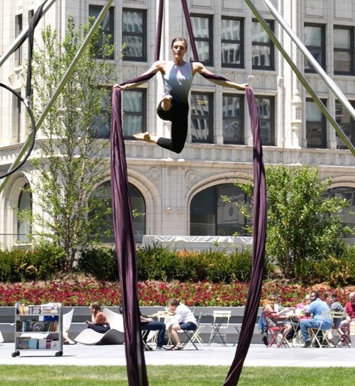 Aerialist performs on the lawn of the green at 320. Aerial Dance Chicago